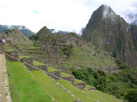 Machu Picchu, terraces and houses, in the background Huayna Picchu